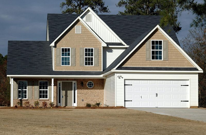 Homeowner reviewing transparent siding installation estimate with contractor in Durham, North Carolina