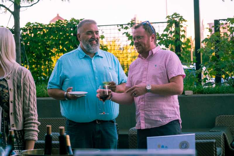 Joey speaking with event goers at the 2025 CFF sips and wiggles event.