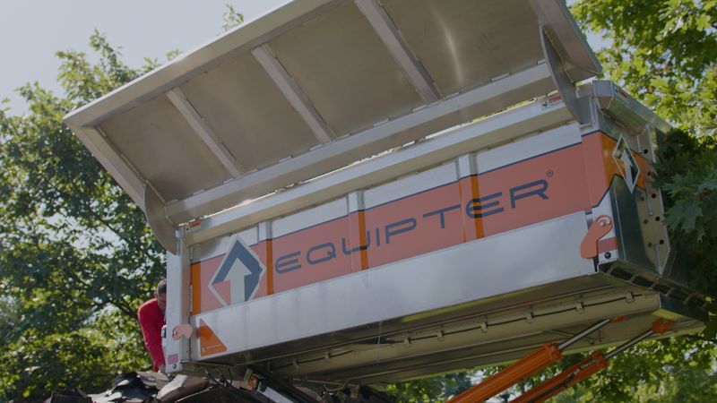 Roof Revivers uses the equipter, a mobile trash collector, to keep the job tidy.