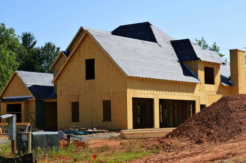 Storm-damaged roof with missing shingles being assessed by certified roof replacement contractors in Durham, North Carolina