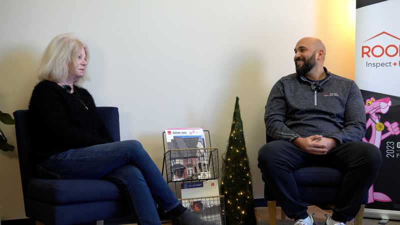 Roof Revivers president Reed Dietz sits for a customer testimonial with Susanne of Village at Deer Creek Condominiums.
