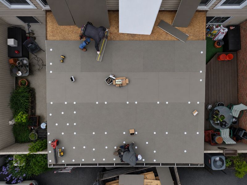 Roof Revivers installing a flat roof during a commercial property management project.